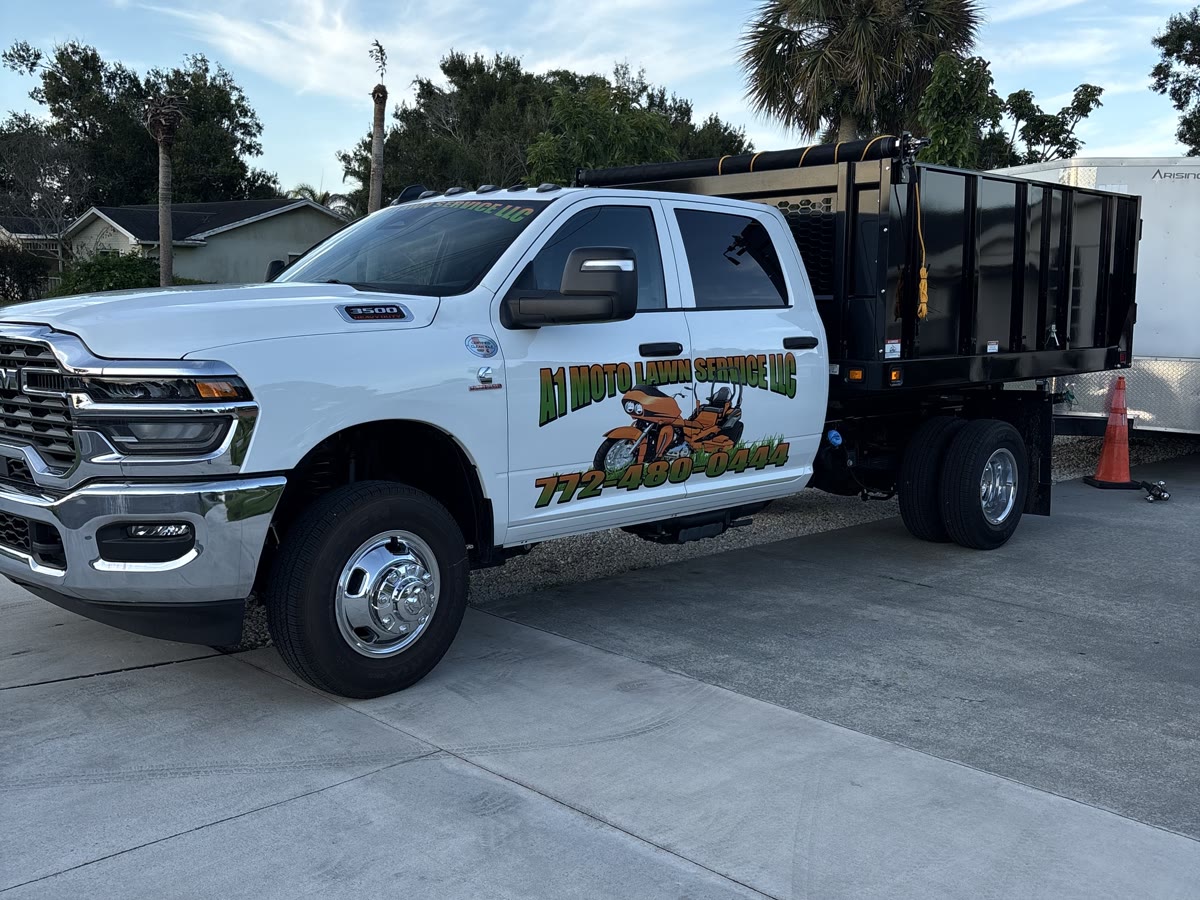 A1 Moto Lawn Service branded work truck and dump trailer in Fort Pierce FL