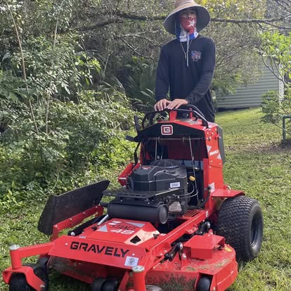 A1 Moto crew operating Gravely commercial stand-on mower in Fort Pierce FL