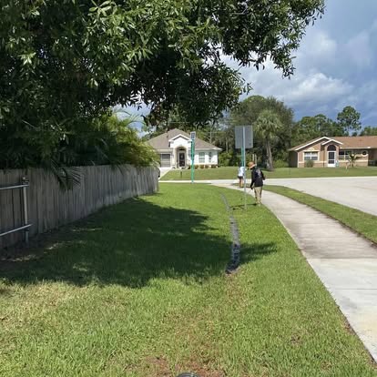 A1 Moto crew maintaining a neighborhood lawn in Fort Pierce FL